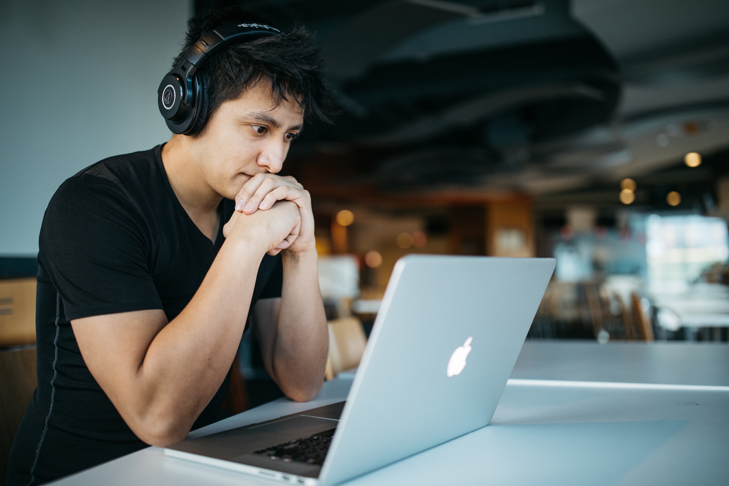 man with headset and macbook